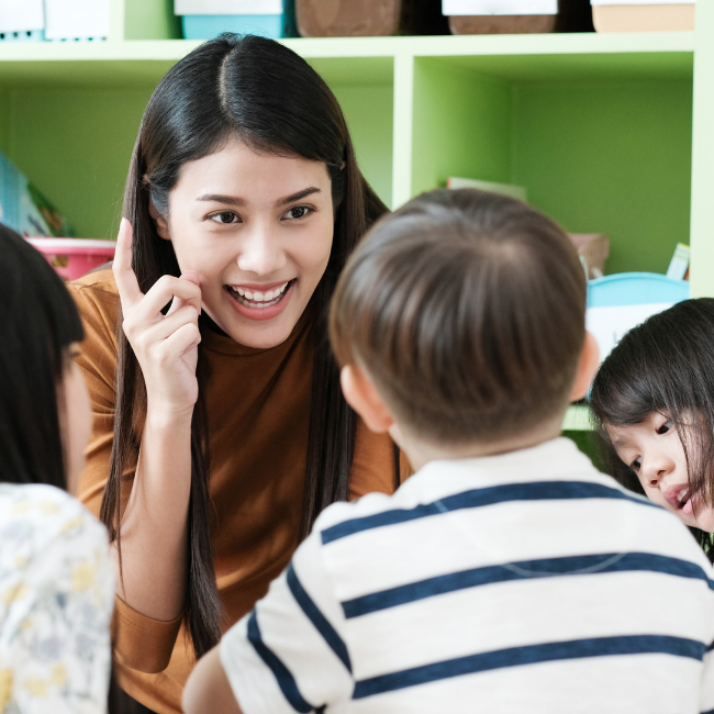 teacher in preschool classroom using behavior management tools 